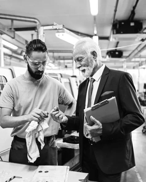 senior-quality-control-inspector-young-worker-cooperating-while-analyzing-manufactured-products-fact_1